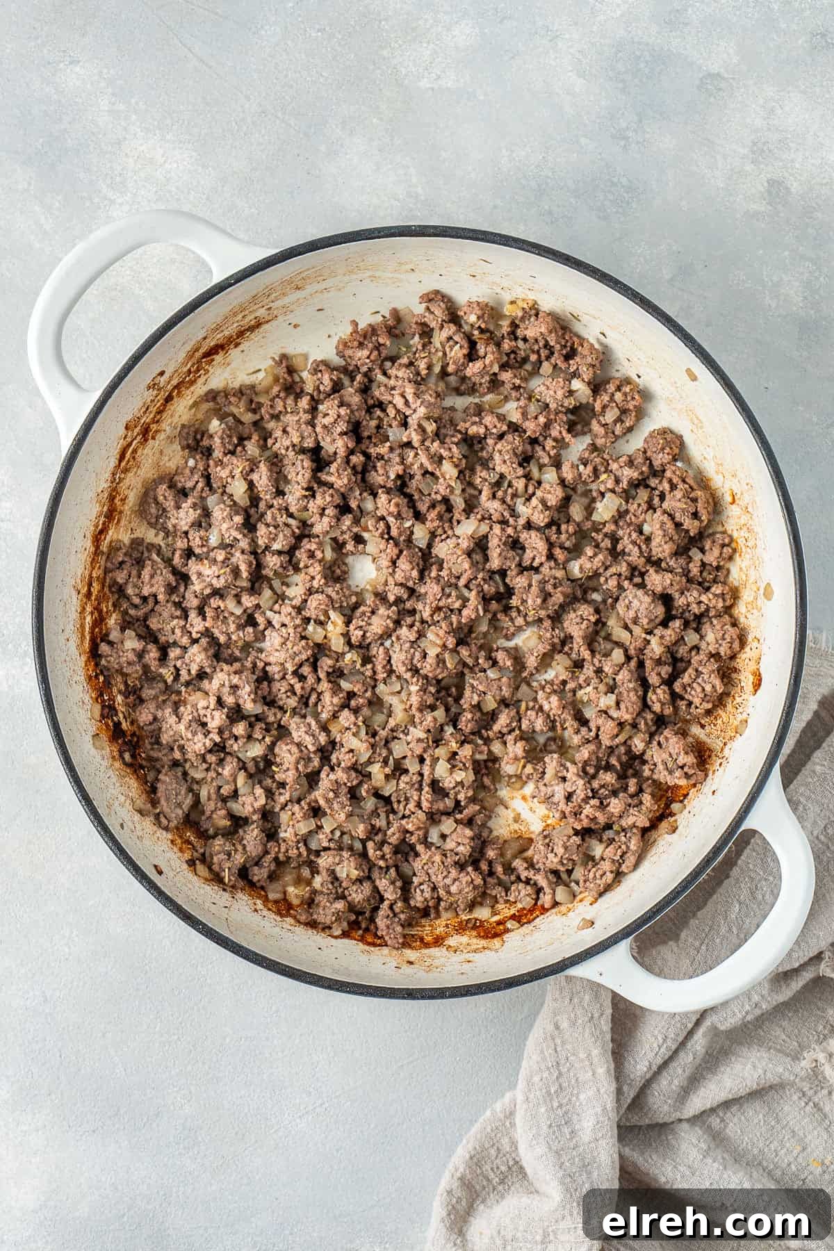 The browned beef in a pan.