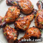 sticky asian chicken drumsticks on a ceramic plate