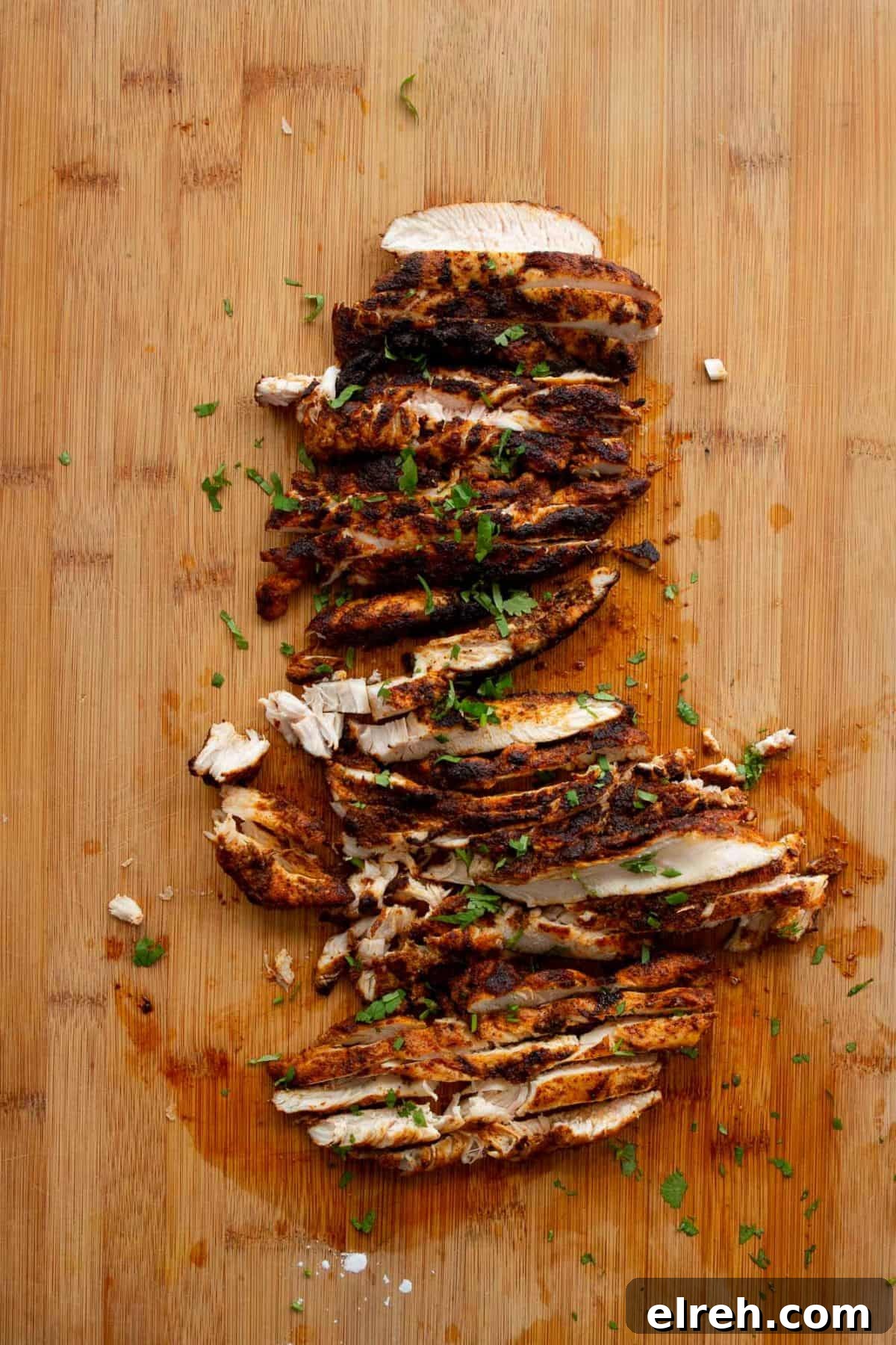 Chicken Fajita Tacos with Grilled Peppers and Onions 8 Thinly sliced seared fajita chicken breast on a cutting board.