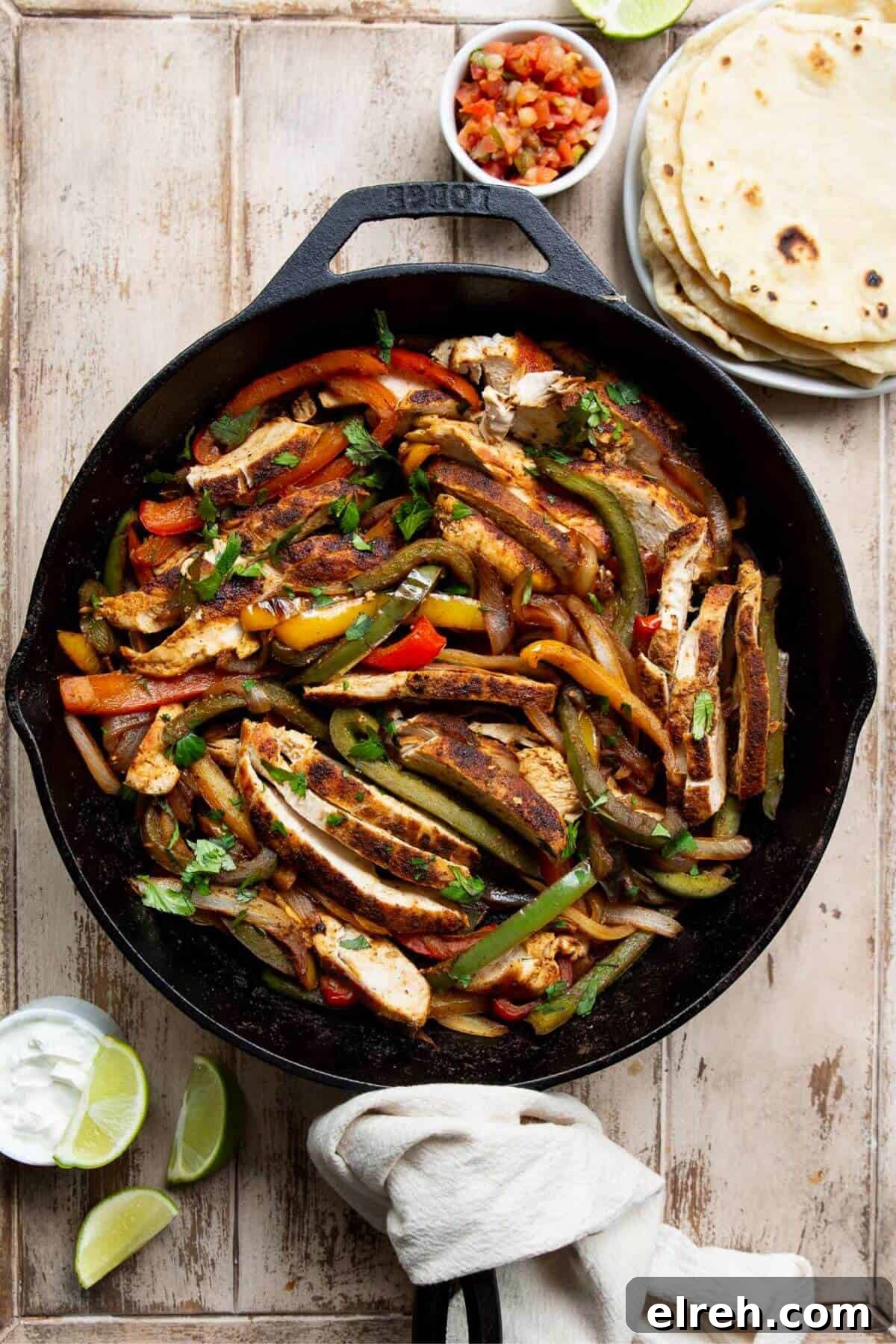 Chicken Fajita Tacos with Grilled Peppers and Onions 10 Cast iron skillet of chicken fajita taco filling with peppers and onions.