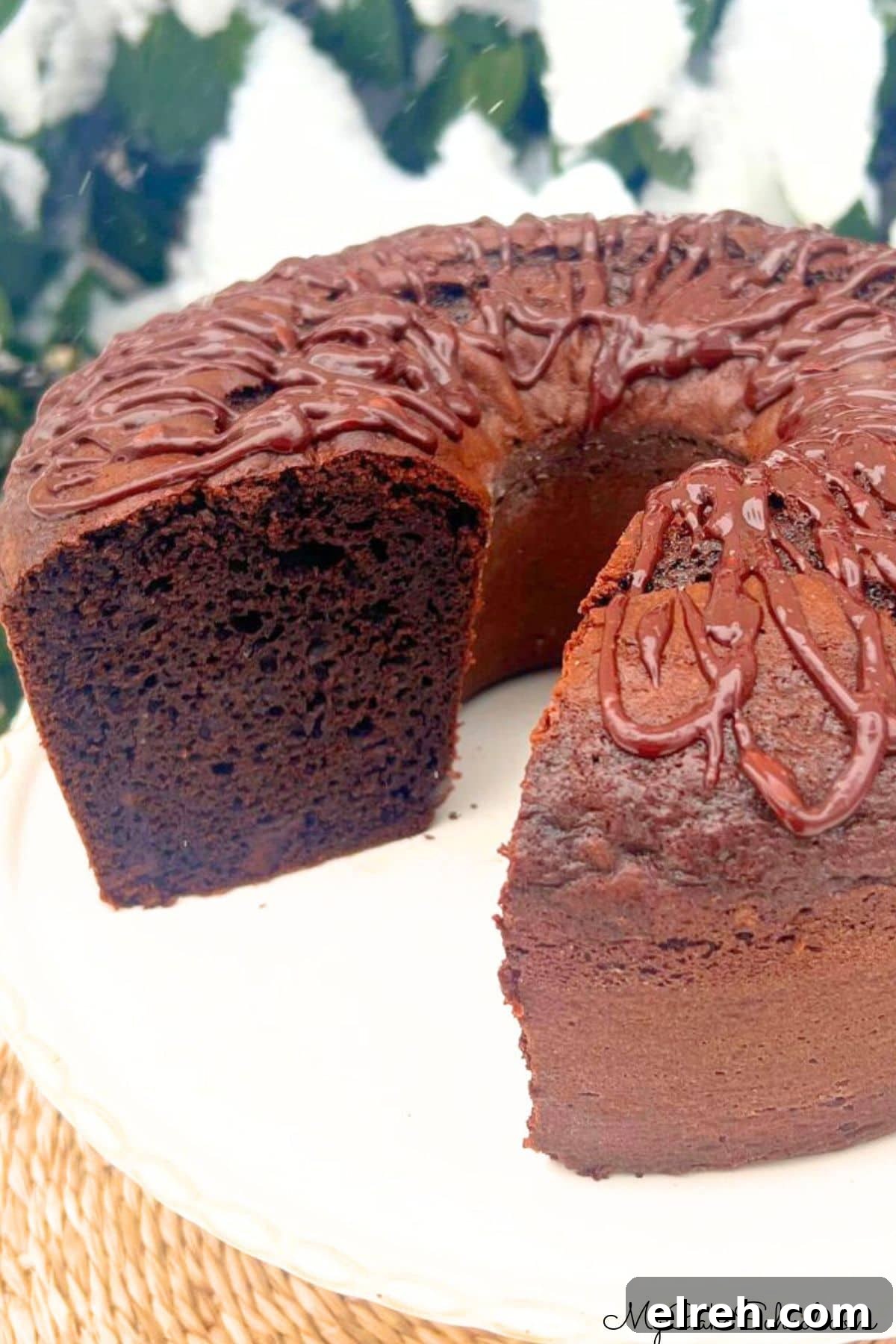 Chocolate Brownie Bundt Cake Recipe 2 Brownie Bundt Cake, sliced, on a cake plate.