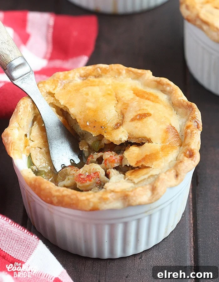 metal fork taking a bite out of a baked crawfish pie