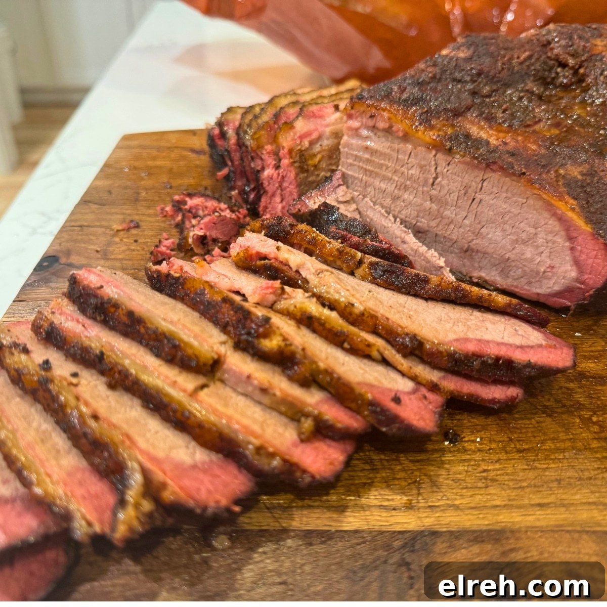 smoked brisket sliced on cutting board