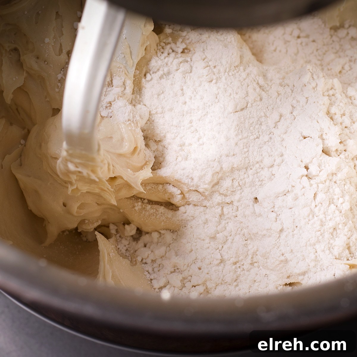 Raspberry Cupcakes Recipe with Cream Cheese Frosting 14 Gently mixing cake flour into the batter.