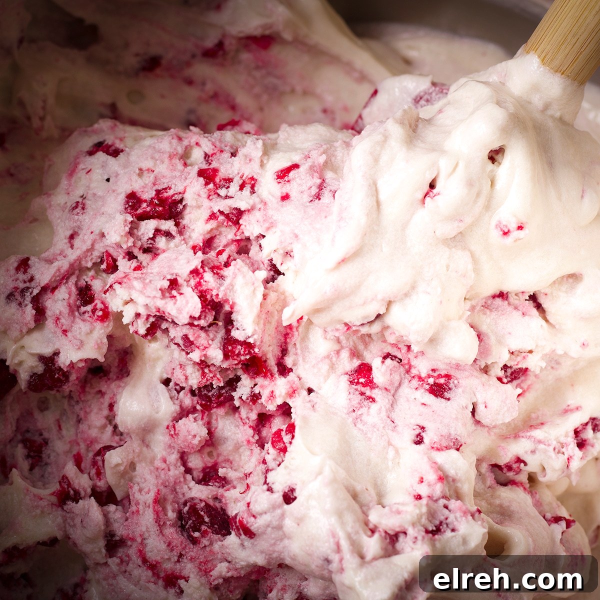 Raspberry Cupcakes Recipe with Cream Cheese Frosting 16 Using a rubber spatula to gently fold frozen chopped raspberries into cupcake batter.