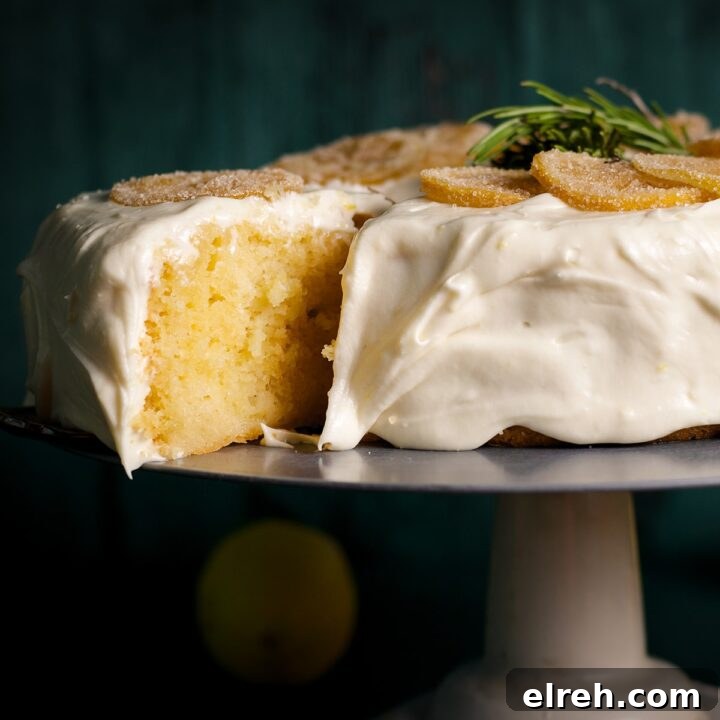 Someone using a spatula to cut and serve a slice of elderflower lemon cake covered in lemon cream cheese frosting.