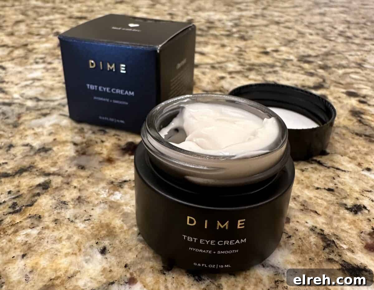 Open jar of DIME TBT Eye Cream on a granite countertop