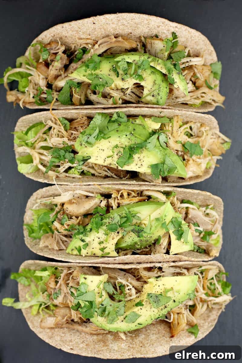 top down view of 4 chicken tacos on a slate platter