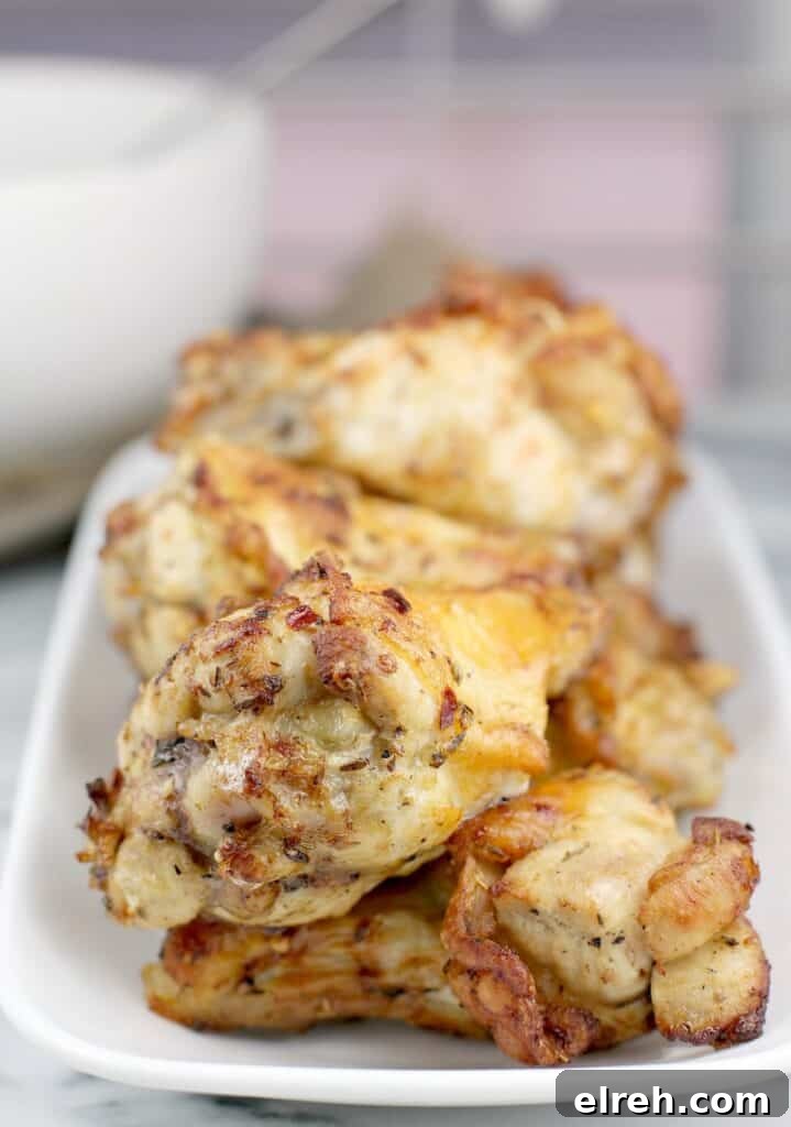 close-up of cooked air fryer chicken wings on a white dish
