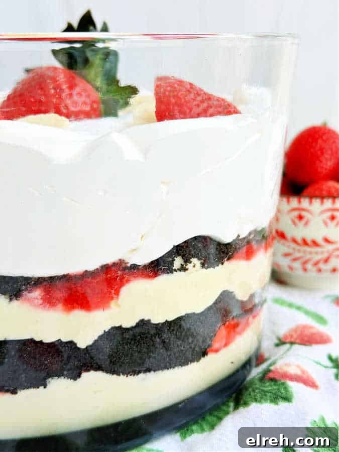 a side view of the trifle bowl so you can see the layers of crushed Oreos, strawberry filling, vanilla pudding and bananas