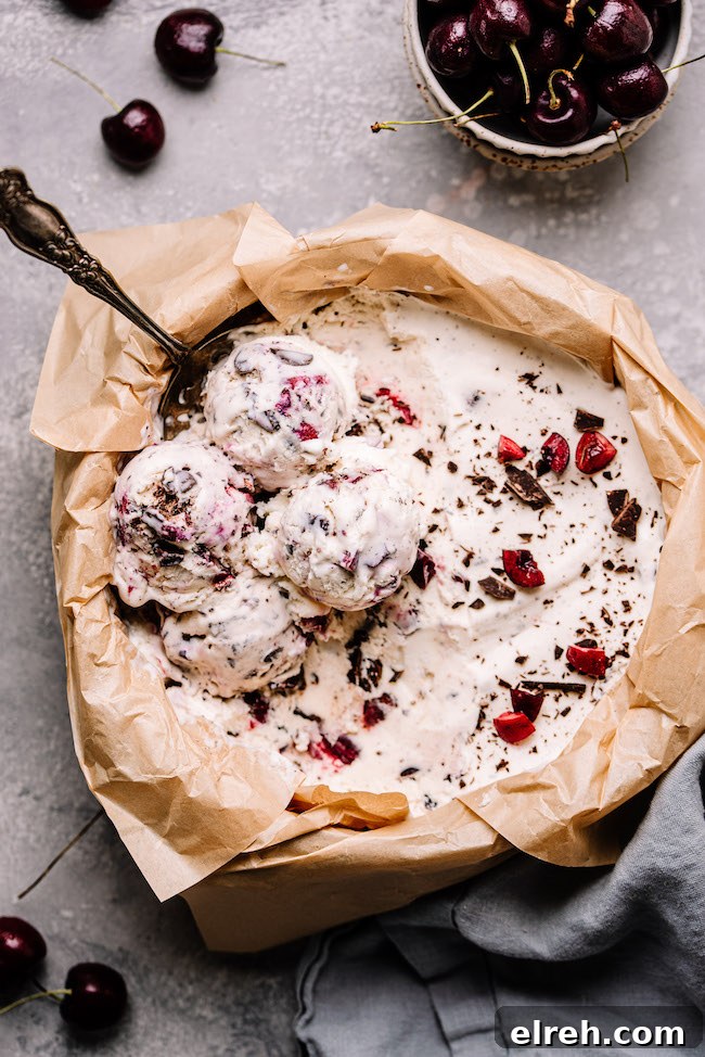 Cherry chocolate ice cream in a large dish with four scoops