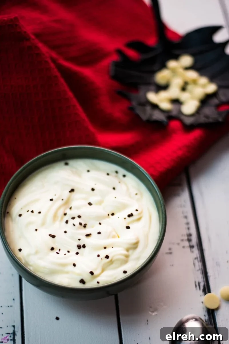 White Chocolate Pudding Recipe to Impress Guests 2 Gorgeous green bowl on white wooden board filled with delicious white chocolate pudding.