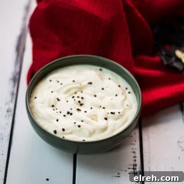 White Chocolate Pudding Recipe to Impress Guests 11 Gorgeous green bowl on white wooden board filled with delicious white chocolate pudding.
