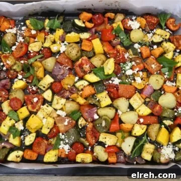 Authentic Homemade Harissa Sauce Recipe 8 mediterranean oven roasted vegetables in a baking sheet.