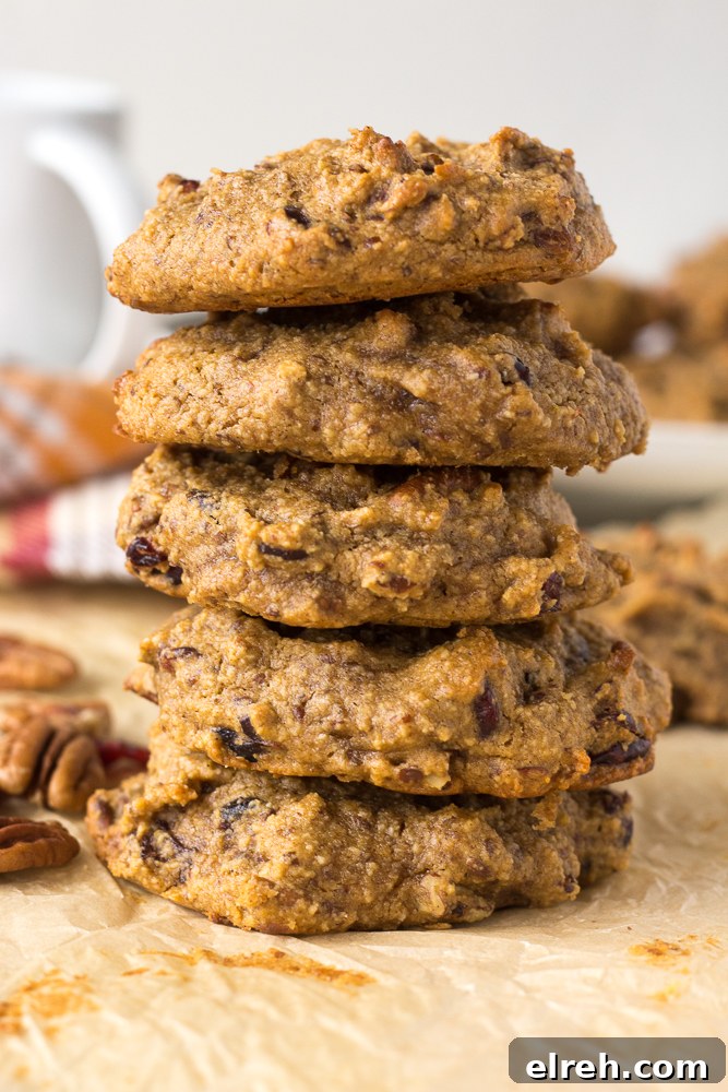 Grain-Free Sweet Potato Breakfast Cookies Recipe 2 Grain-Free Sweet Potato Breakfast Cookies stacked on parchment paper by Flora & Vino
