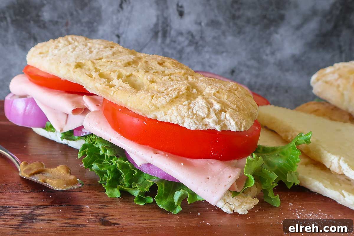 11 Gluten-Free Rolls and Buns: Soft, Fluffy Recipes 12 long soft with a crispy crust submarine roll filled with ham, tomato, onions and lettuce on a wooden board