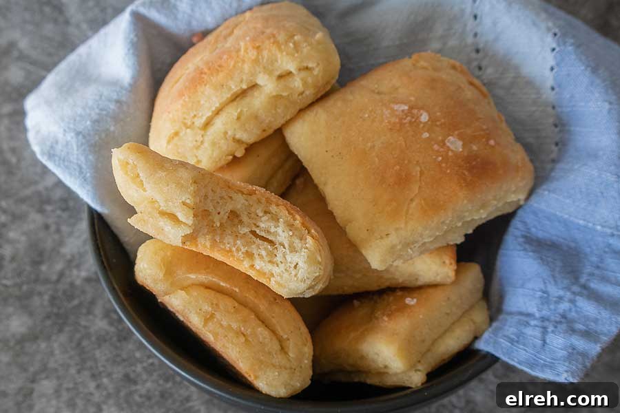 11 Gluten-Free Rolls and Buns: Soft, Fluffy Recipes 5 Buttery, folded, and fluffy gluten-free Parker House rolls, puffed up, soft, in a bowl.