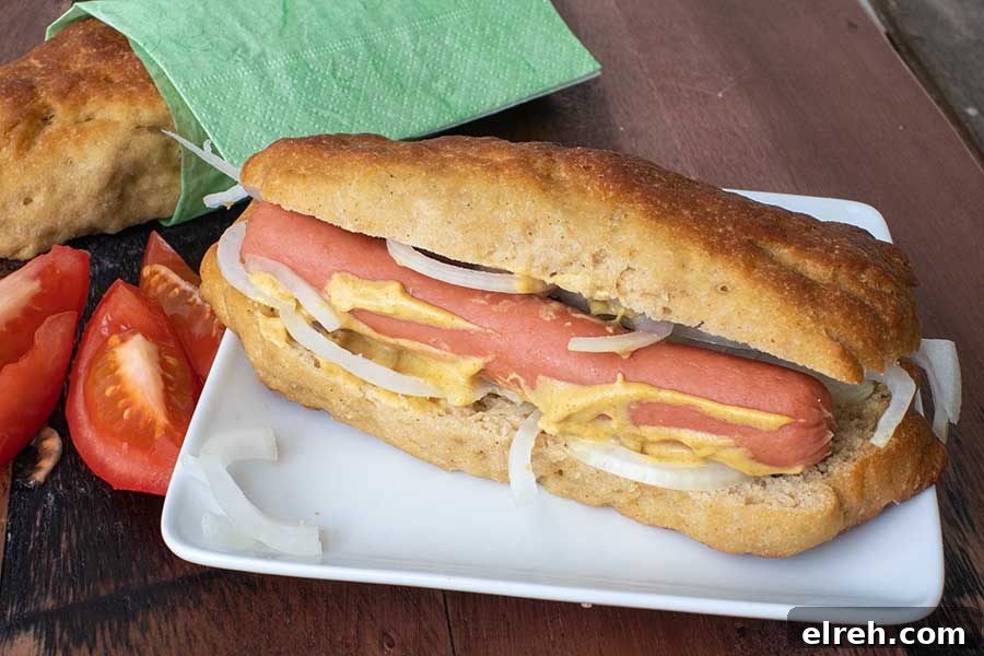 11 Gluten-Free Rolls and Buns: Soft, Fluffy Recipes 7 Soft, delicious homemade gluten-free hot dog bun filled with hot dog on a plate
