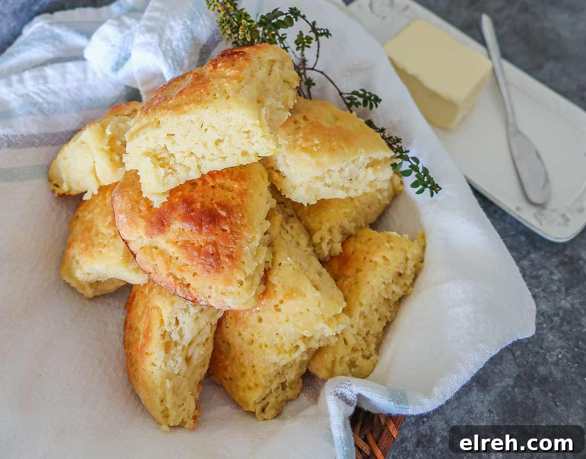 11 Gluten-Free Rolls and Buns: Soft, Fluffy Recipes 8 gluten free milk rolls in a towel with butter dish on the side