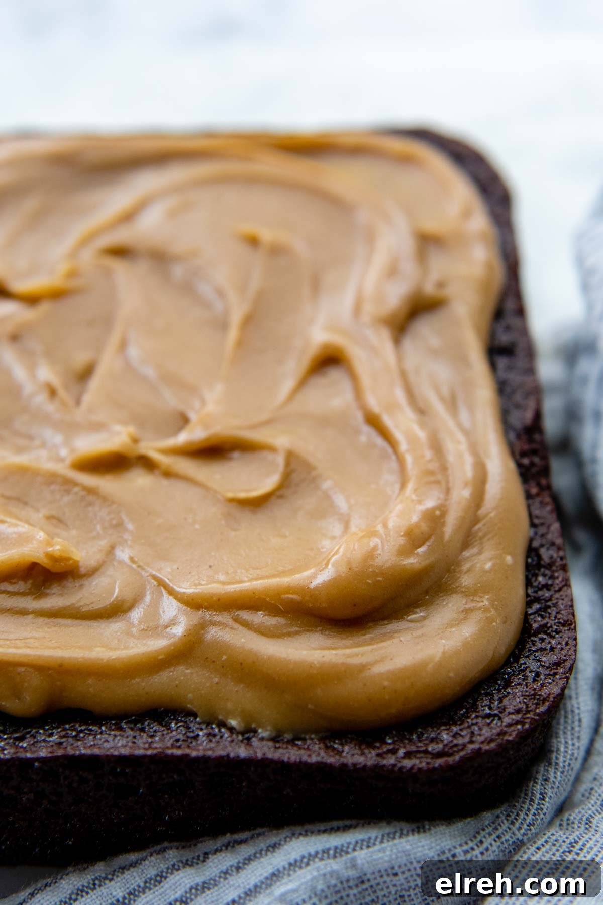 close up of peanut butter frosting on a chocolate cake.
