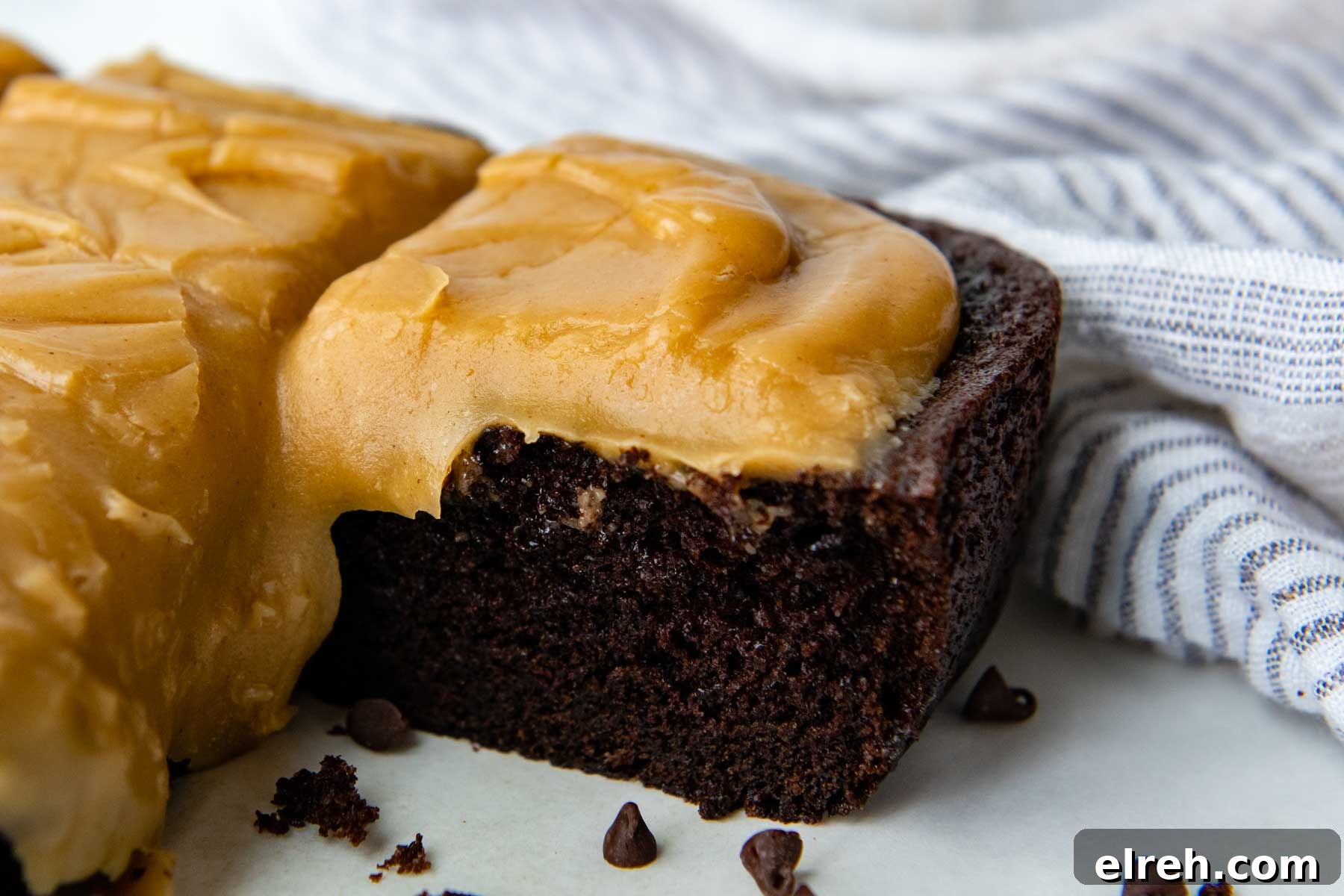 a slice of cake with glaze dripping down.