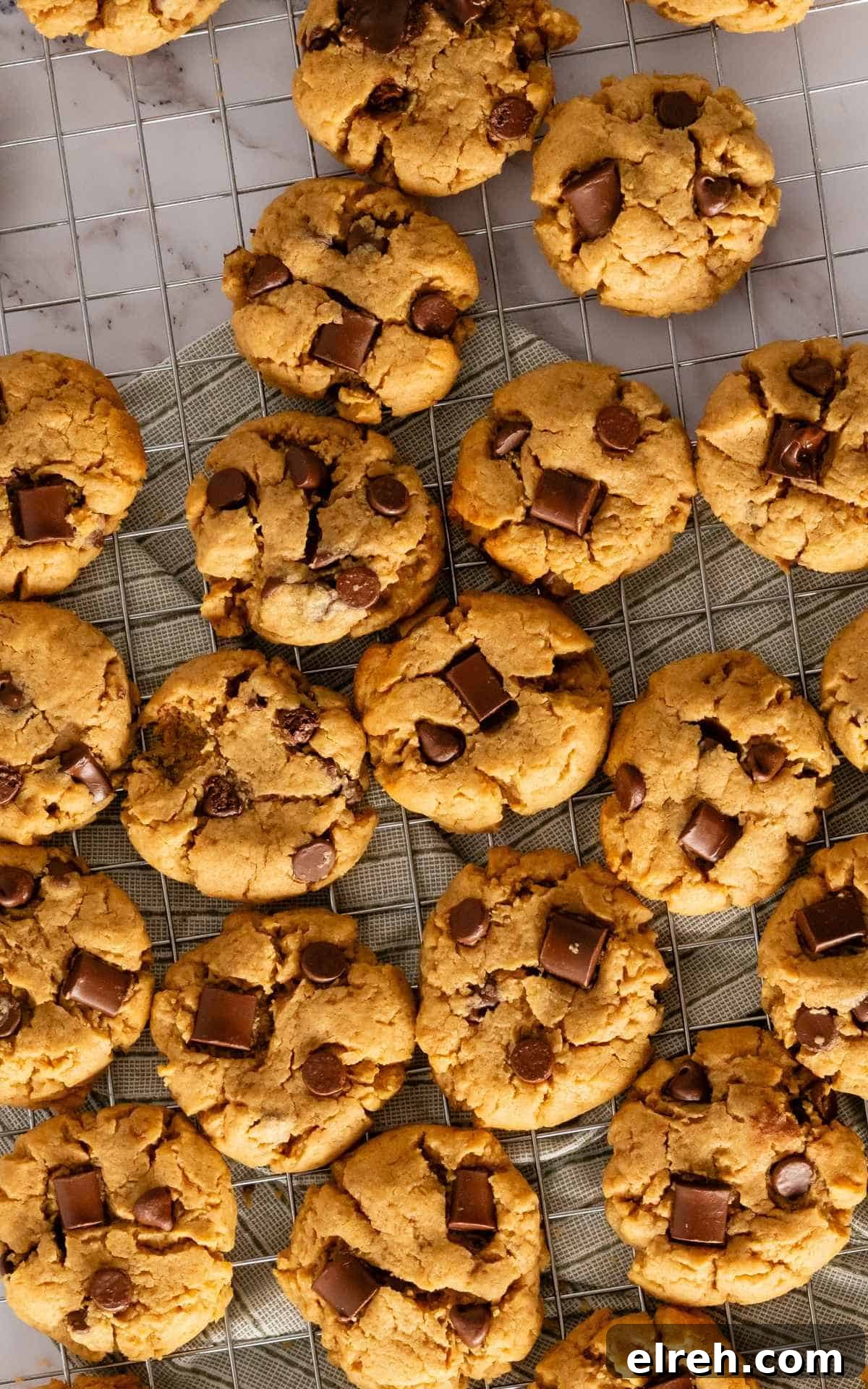 Chewy Peanut Butter Chocolate Chip Cookies Recipe 3 Birds eye view of peanut butter cookies with chocolate chips and chocolate chunks on cooling rack.