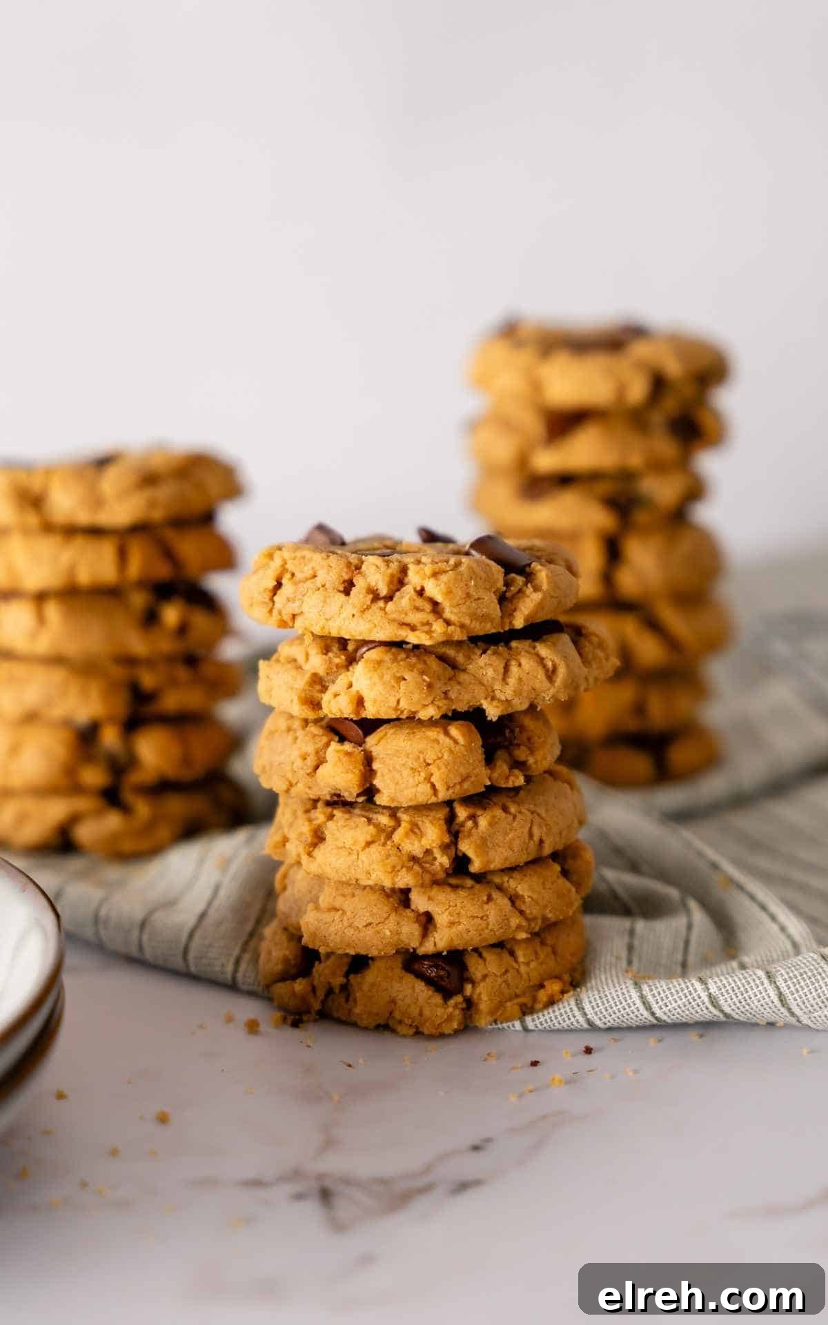 Chewy Peanut Butter Chocolate Chip Cookies Recipe 5 Three tall stacks of peanut butter chocolate chip cookies.
