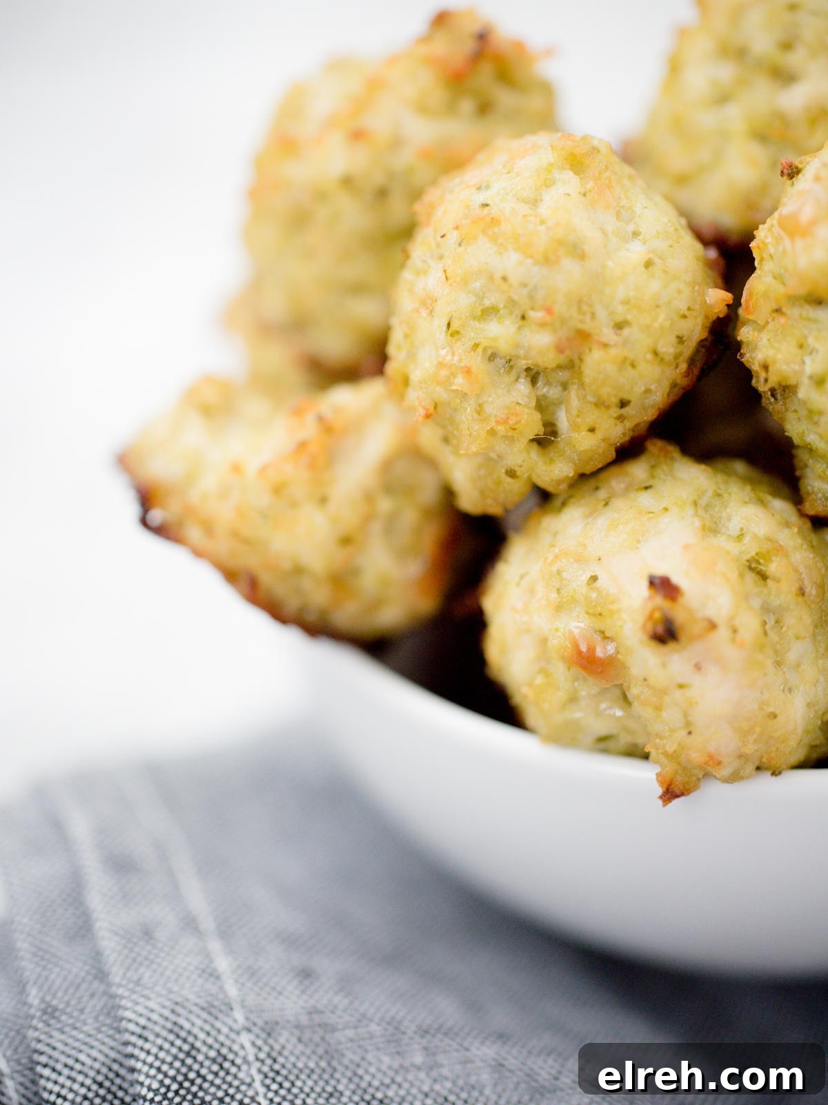 white bowl full of chicken pesto meatballs