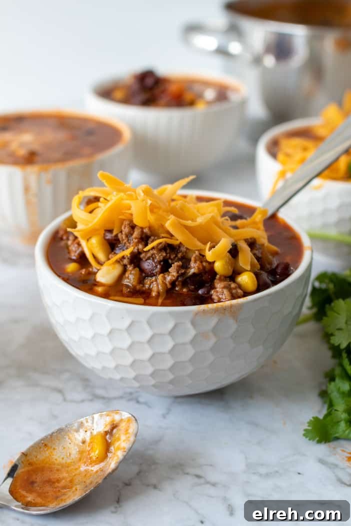 Taco Soup topped with shredded cheese.
