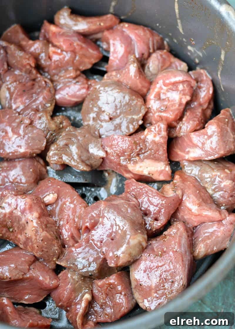Steak tips arranged in an air fryer basket