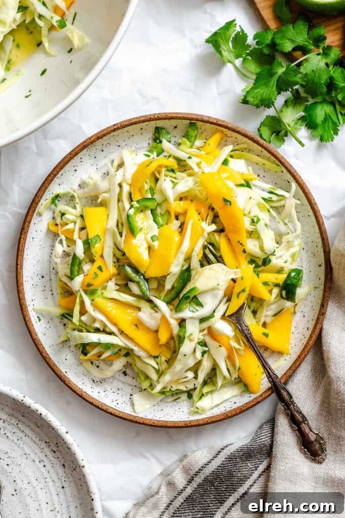 Easy Mango Cabbage Coleslaw on a white plate 