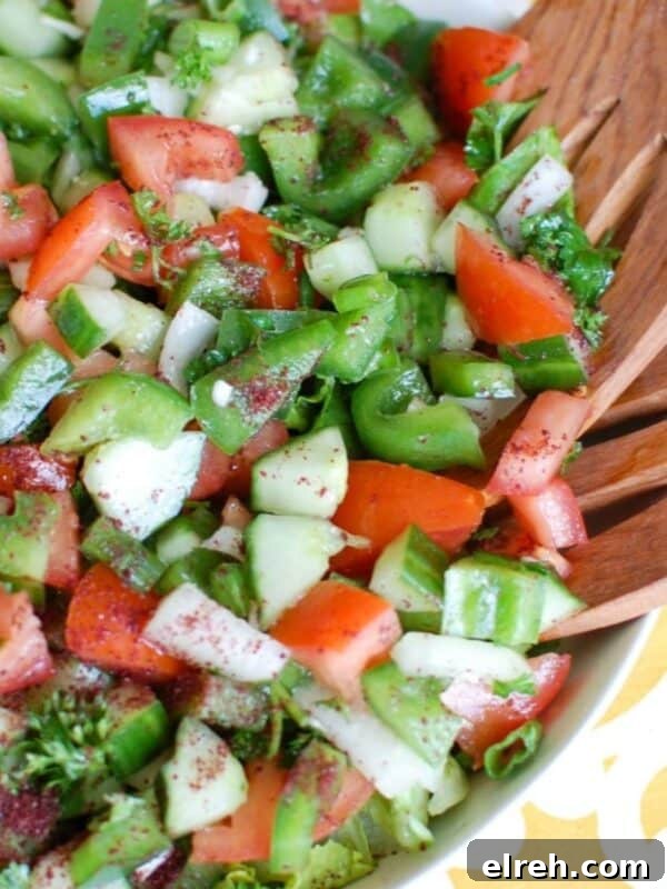 Easy Lebanese Salad in white bowl with wooden spoons