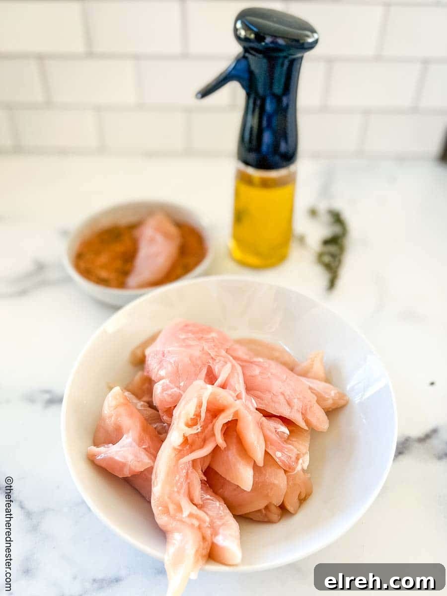 bowl of raw chicken strips.