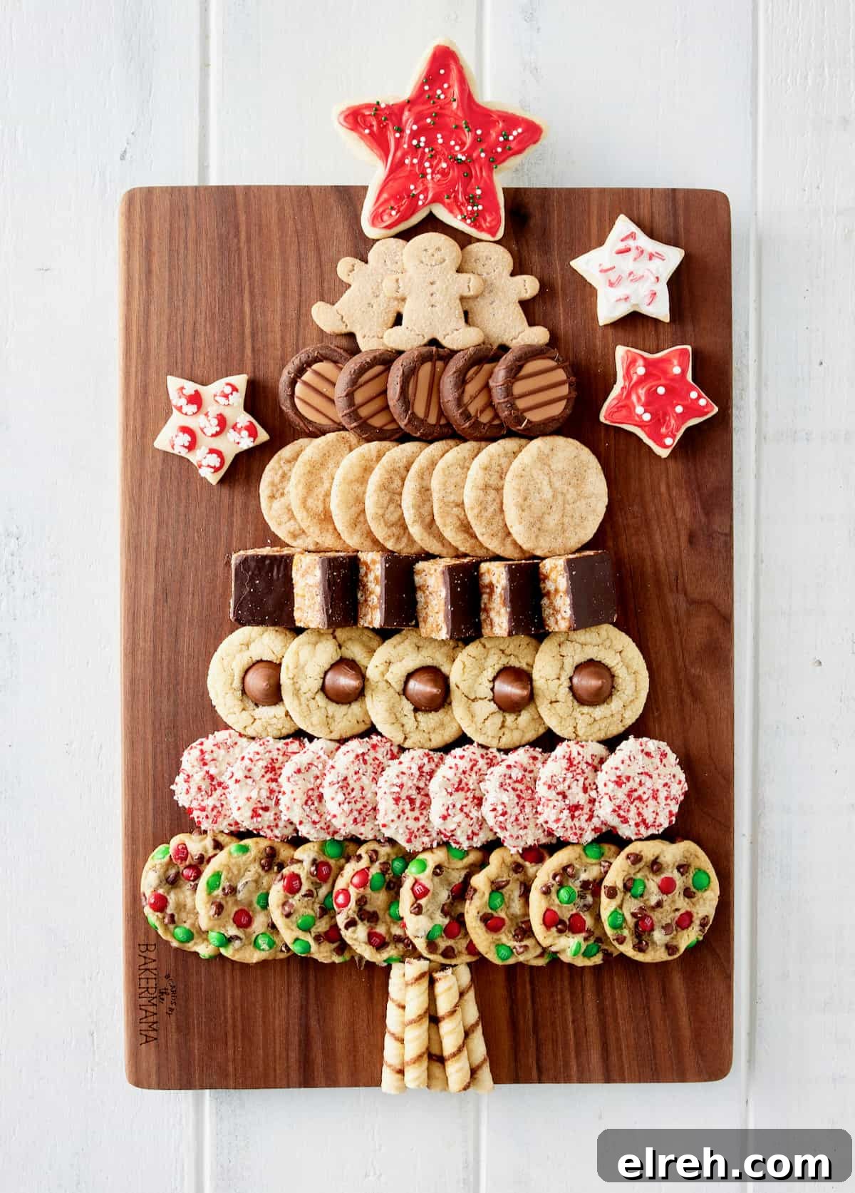 Throw an Ugly Sweater Holiday Party: Ideas and Tips 9 A variety of holiday cookies laid out on a rectangular wood food board in the shape of a Christmas tree with a red frosted star cookie on top.