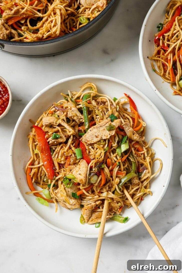 Top view of a bowl of Hakka Noodles with a pair of chopsticks.