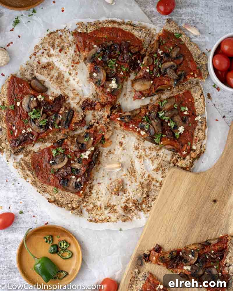 How to Make Mushroom Pizza with Cauliflower Crust 17 close up of Mushroom Pizza Recipe with Cauliflower Crust sliced on parchment paper