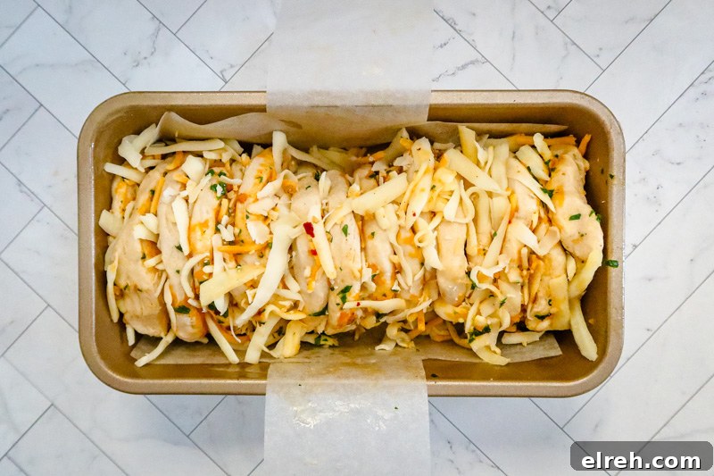 Pull apart garlic bread arranged in the pan and ready to bake.