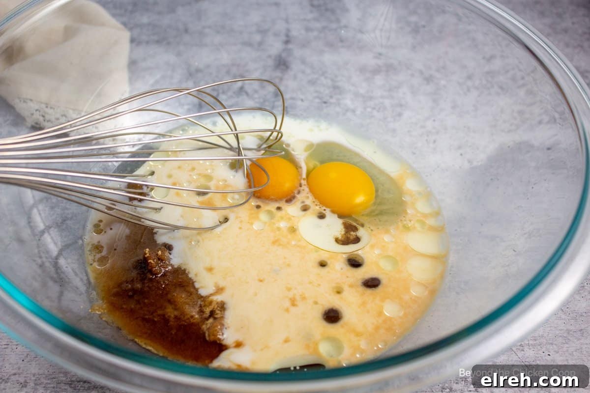 Eggs, milk and oil together in a mixing bowl.
