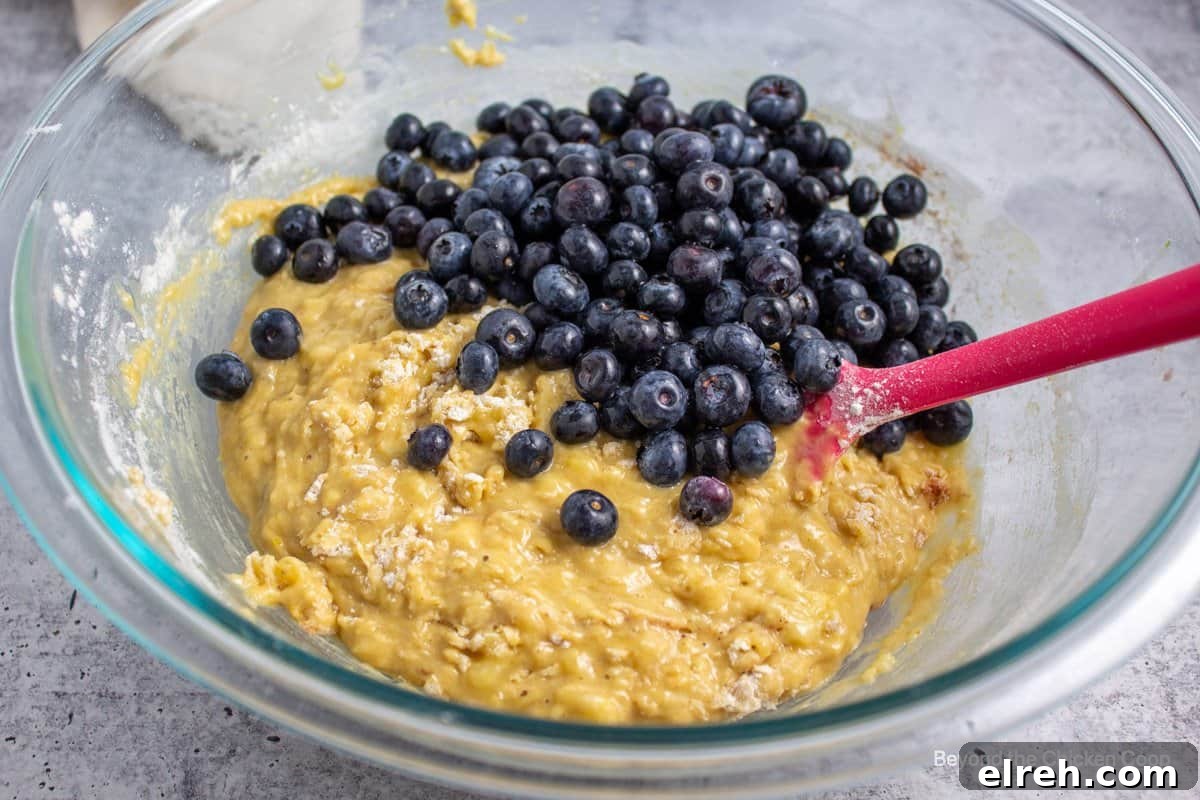 Fresh blueberries on muffin batter.