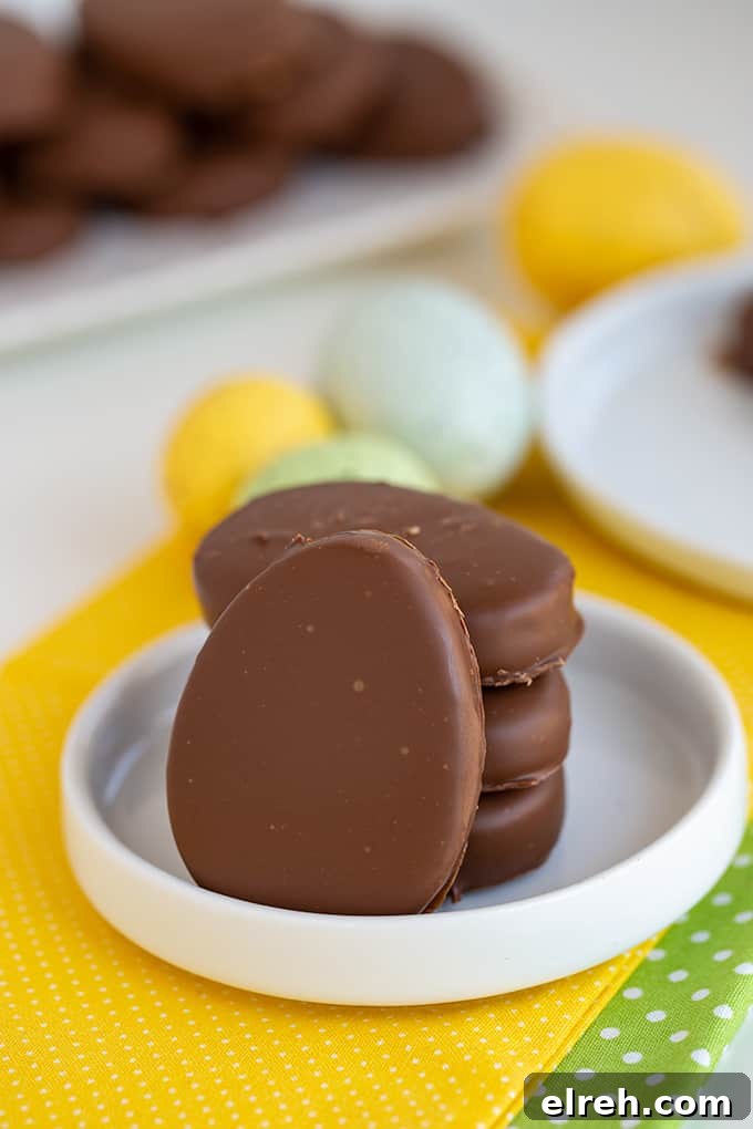 Chocolate Peanut Butter Eggs Recipe 2 peanut butter eggs on a small white plate with yellow and green linen under them