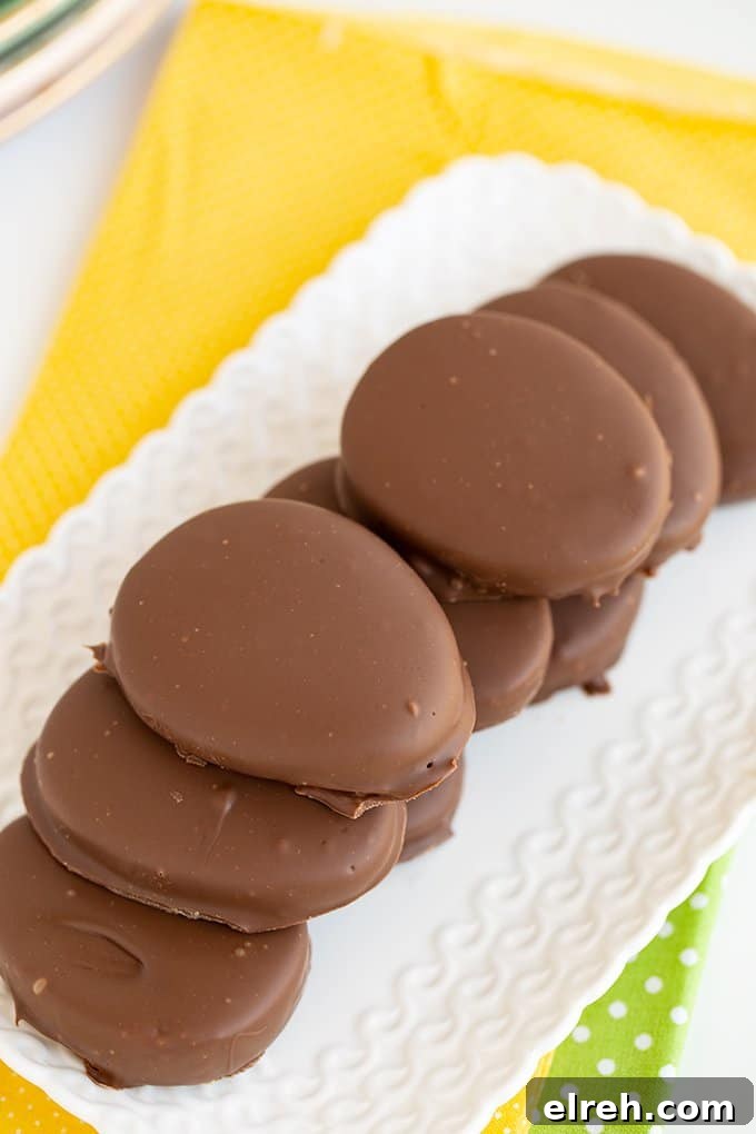 Chocolate Peanut Butter Eggs Recipe 8 stacked peanut butter eggs on a small white platter