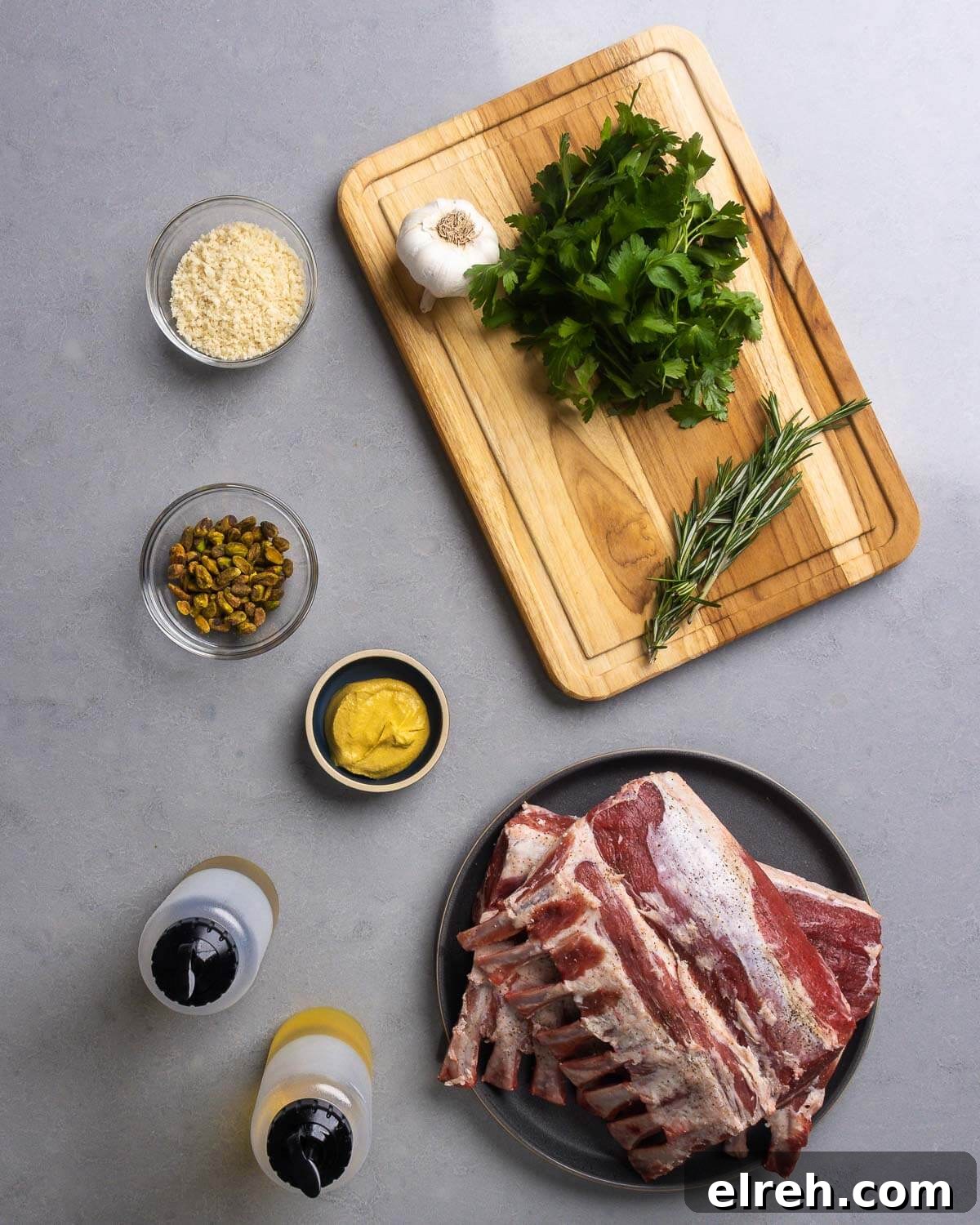 Ingredients shown: panko breadcrumbs, garlic, parsley, rosemary, pistachios, Dijon mustard, olive oil, and 2 racks of lamb.
