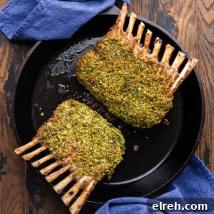Herb crusted rack of lamb in cast iron pan.