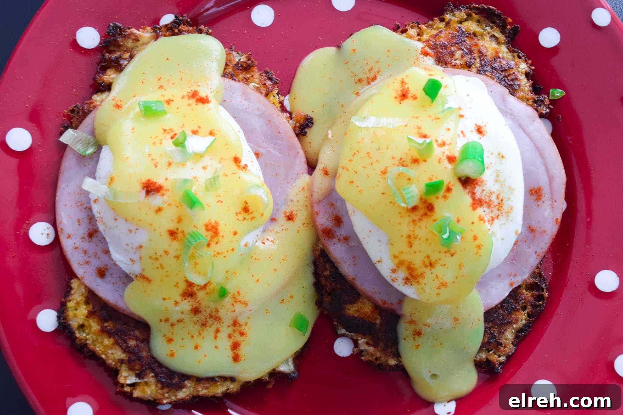 Cauliflower Eggs Benedict with Creamy Hollandaise 4 cauliflower benedict served on red plate overhead shot