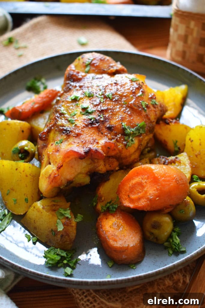 Sheet Pan Moroccan Chicken Dinner with Warm Spices 2 Moroccan chicken and vegetables on a plate.