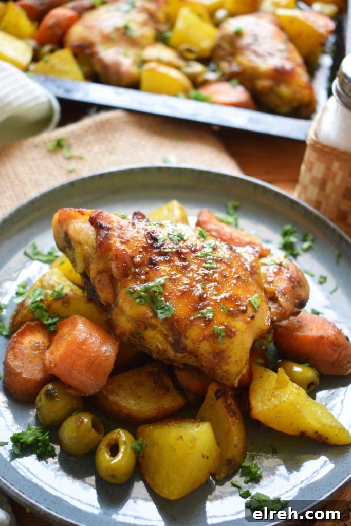 Sheet Pan Moroccan Chicken Dinner with Warm Spices 13 Moroccan chicken and vegetables on a plate.