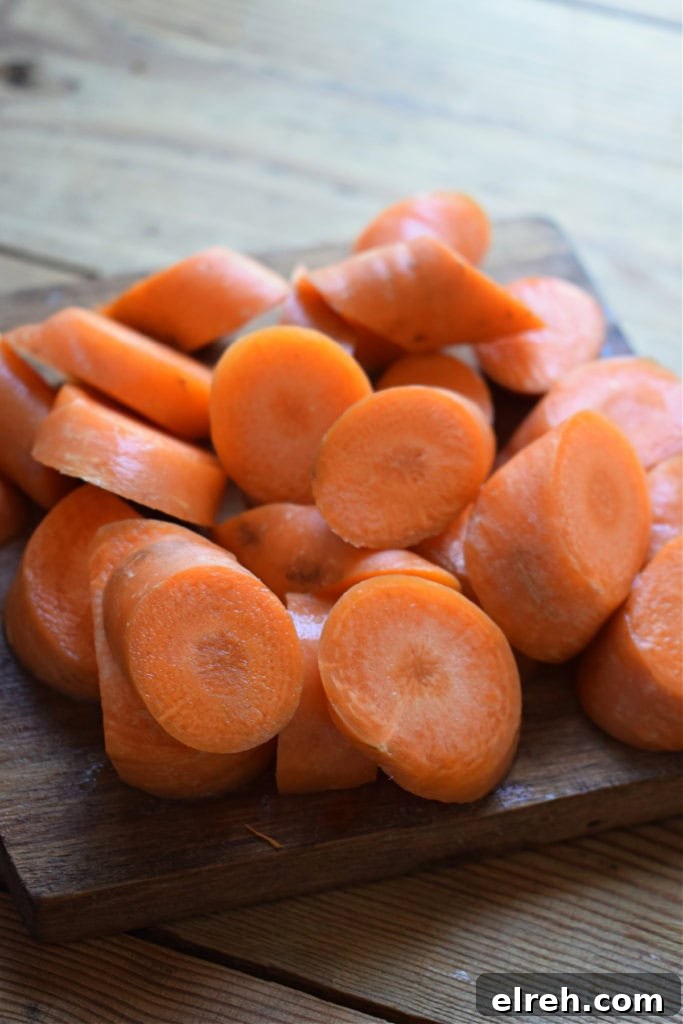 Sheet Pan Moroccan Chicken Dinner with Warm Spices 6 Cut carrots on a cutting board.