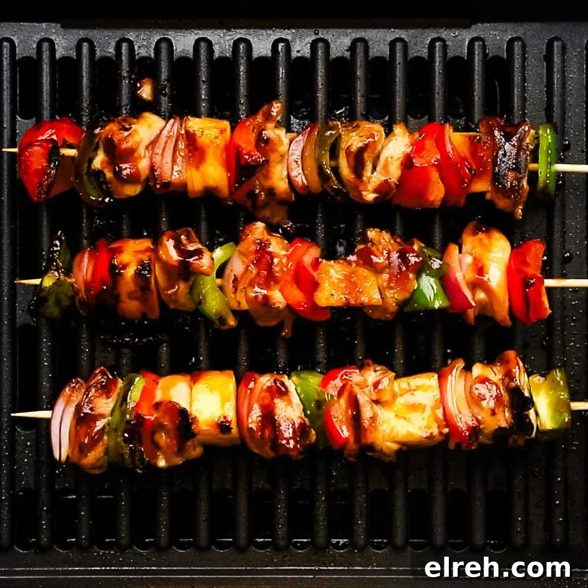 chicken skewers cooking on a grill pan
