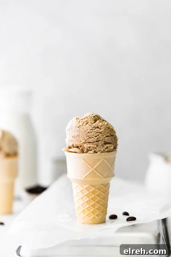 a scoop of No Churn Coffee Ice Cream in an ice cream cone