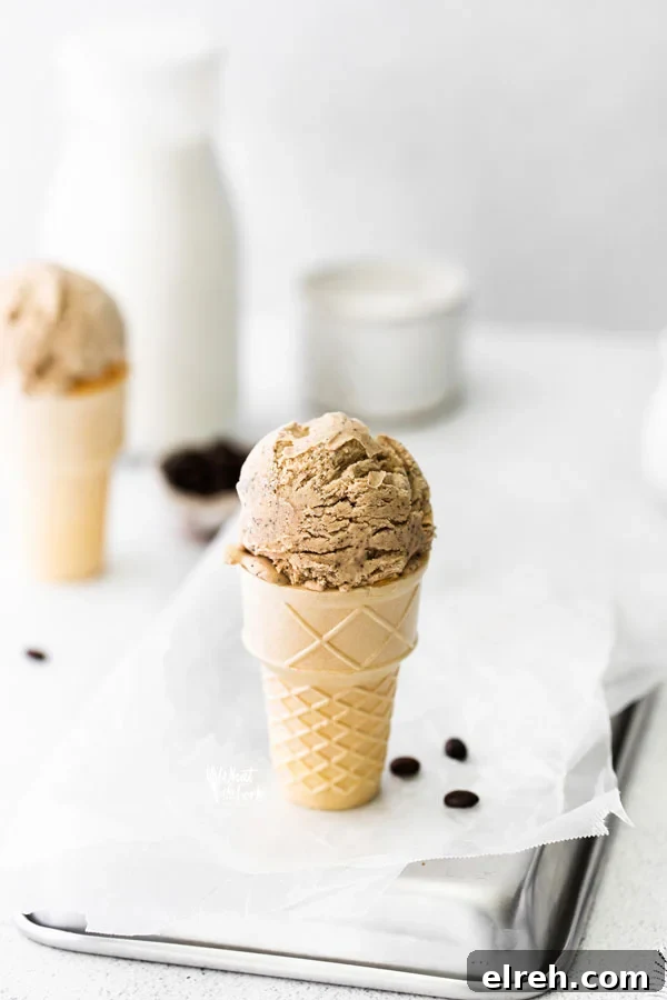 a scoop of No Churn Coffee Ice Cream in an ice cream cone